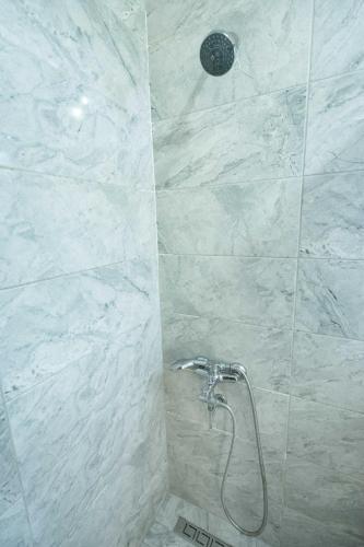 a shower with a shower head in a bathroom at Hotel Libiza in Gebze
