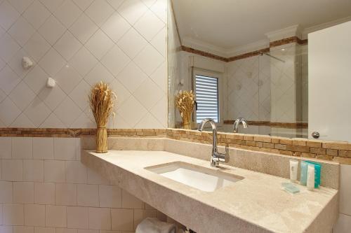 a bathroom with a sink and a mirror at Apartamentos Castaví in Es Pujols