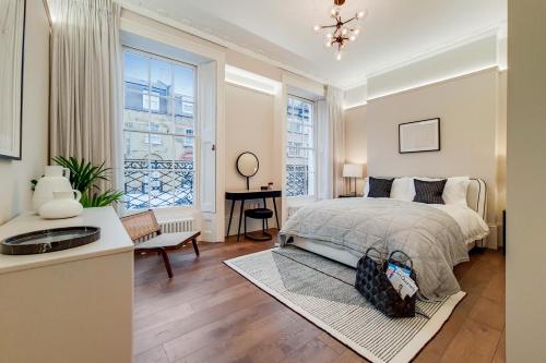a bedroom with a bed and a large window at Argyle Apartments, Kings Cross in London