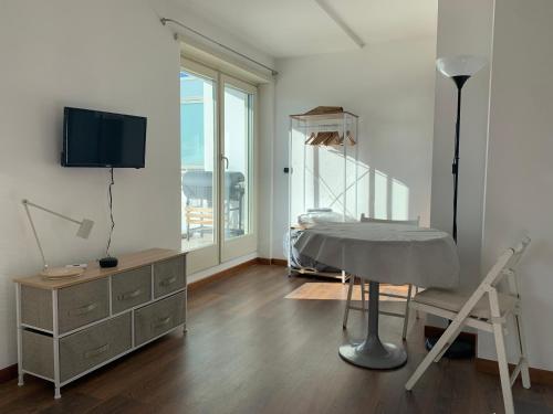a living room with a bed and a tv at Trastevere Studio Flat - Zen Real Estate in Rome