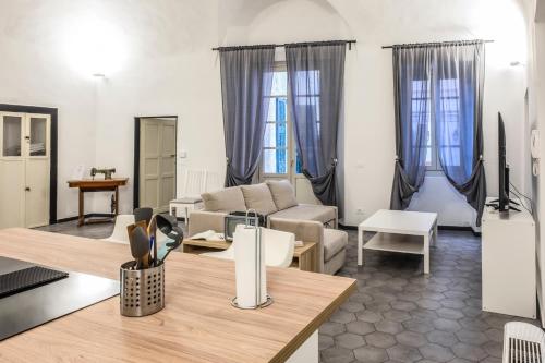 a living room with a couch and a table at Affittacamere Archivolto del Teatro in Albenga