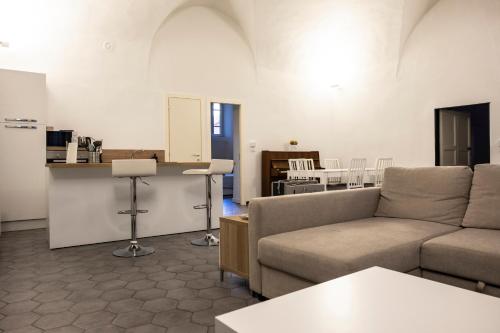 a living room with a couch and a table at Affittacamere Archivolto del Teatro in Albenga