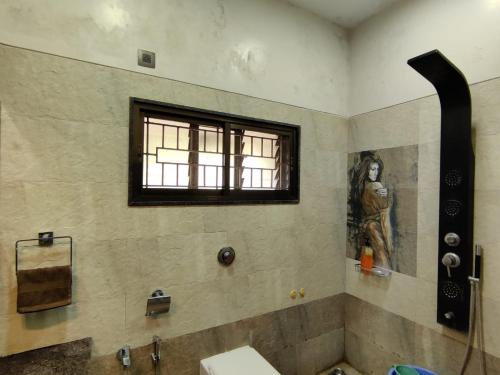 a bathroom with a sink and a window at Sea Nest Villa, 3BHK Panoramic Sea View , Ganpatipule in Ratnagiri