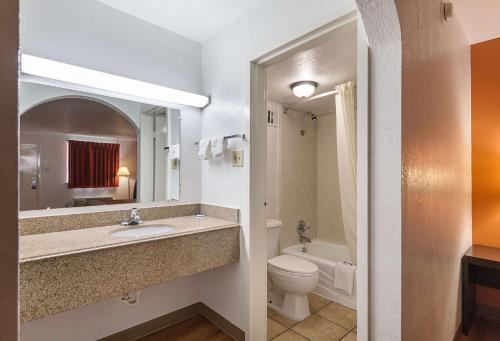 a bathroom with a sink and a toilet and a mirror at Motel 6 San Antonio TX I10 West in San Antonio