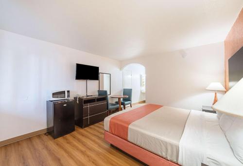 a hotel room with a bed and a television at Motel 6 San Antonio TX I10 West in San Antonio