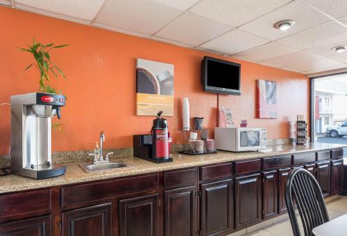a kitchen with a counter with a sink and a tv at Motel 6 San Antonio TX I10 West in San Antonio