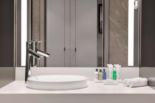 a bathroom counter with a sink and a mirror at Radisson Blu Hotel Riyadh Convention and Exhibition Center in Riyadh