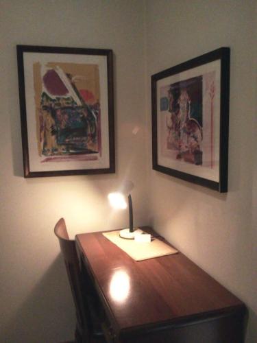 a wooden table with a lamp on top of it at Albergo Al Portico in Azzano Decimo