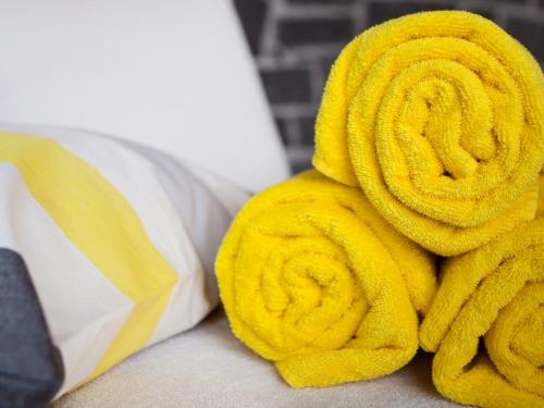 a pile of yellow towels on a bed at Bergesgrün in Oberstdorf