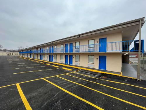 a building with blue doors in a parking lot at Super 8 by Wyndham Paducah I-24 Exit 4 in Paducah