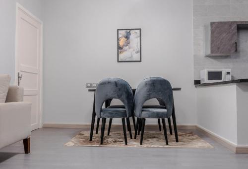 two chairs sitting next to a table in a room at El Gouna Elite Worldwide Sea & Garden Residences - Hurghada, Egypt in Hurghada