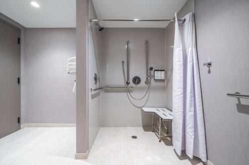 a bathroom with a shower and a sink at Hyatt Place Gainesville Downtown in Gainesville
