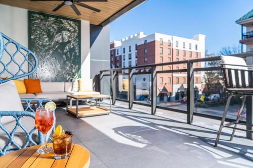 a balcony with a table with a wine glass on it at Hyatt Place Gainesville Downtown in Gainesville