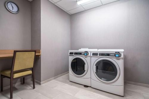 a washing machine and a chair in a room at Hyatt Place Gainesville Downtown in Gainesville
