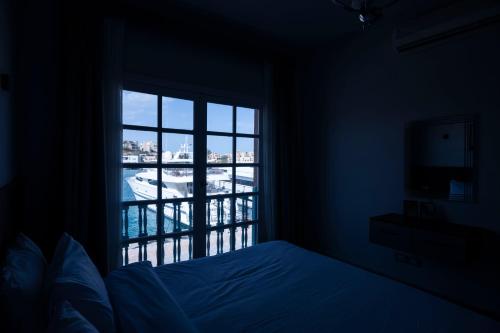 a bedroom with a window with a view of a pool at El Gouna Elite Worldwide Sea & Garden Residences - Hurghada, Egypt in Hurghada