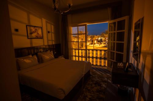 a bedroom with a bed and a window with a view at El Gouna Elite Worldwide Sea & Garden Residences - Hurghada, Egypt in Hurghada