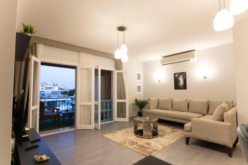 a living room with a couch and a table at El Gouna Elite Worldwide Sea & Garden Residences - Hurghada, Egypt in Hurghada