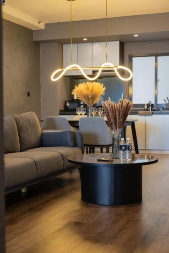 a living room with a couch and a table at Elegant Seaview Projector Lounge by The Only Bnb in Tanjong Tokong