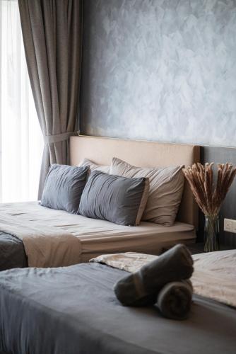 a bedroom with two beds and a large window at Elegant Seaview Projector Lounge by The Only Bnb in Tanjong Tokong