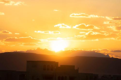 a sunset with the sun setting in the sky at El Gouna Elite Worldwide Sea & Garden Residences - Hurghada, Egypt in Hurghada