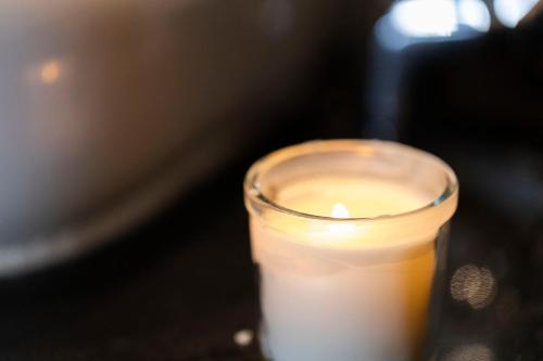 a candle in a glass sitting on a table at El Gouna Elite Worldwide Sea & Garden Residences - Hurghada, Egypt in Hurghada