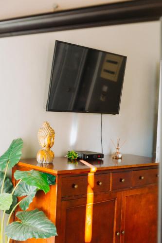 a flat screen tv on top of a wooden dresser at Rhodes Old town apartment manos in Rhodes Town