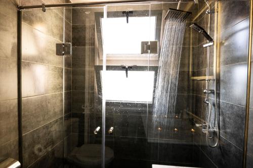 a bathroom with a shower and a window at El Gouna Elite Worldwide Sea & Garden Residences - Hurghada, Egypt in Hurghada