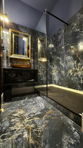 a bathroom with a sink and a mirror and a tub at LUX 114 APARTMENT in Košice