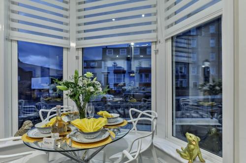 a dining room with a table and a large window at The Apartment - Ground Floor - Luxury for up to 4 guests near Open Air Theatre and North Bay in Scarborough