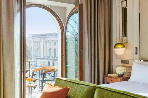 a hotel room with a bed and a balcony at InterContinental Athenee Palace Bucharest by IHG in Bucharest