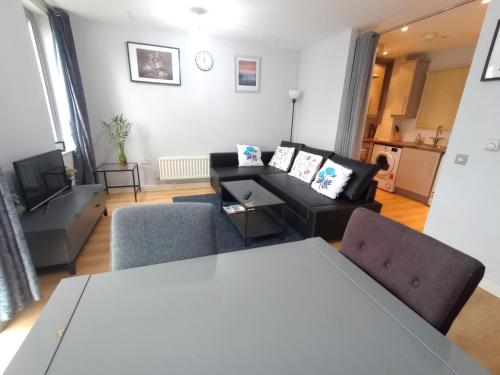 a living room with a couch and a table at London Luxury Holiday Home B in London