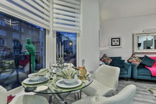 a living room with a glass table and white chairs at The Monroe - 2nd Floor - Luxury for up to 4 guests near Open Air Theatre and North Bay in Scarborough