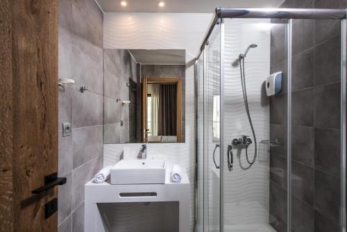 a bathroom with a sink and a shower at Harma Boutique Hotel in Hersonissos