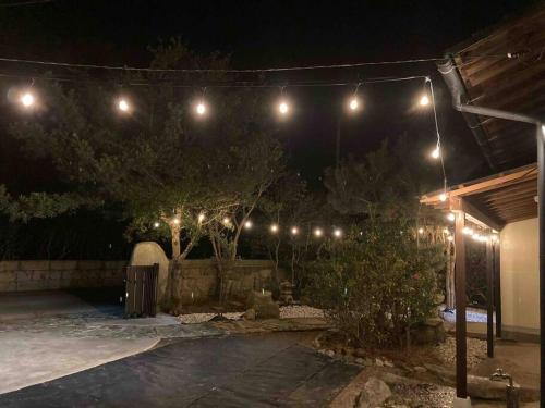 a yard at night with lights on a fence at 貸切海別荘　手ぶらBBQ 海まで徒歩5分ペット可　駐車場5台以上 in Kido