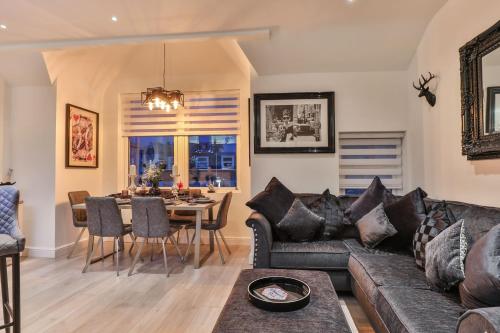 a living room with a couch and a table at The Hepburn - Top Floor - Luxury for up to 6 guests near Open Air Theatre and North Bay in Scarborough