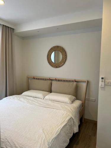 1 dormitorio con 1 cama con espejo en la pared en SkyPark Laguna Phuket, en Bang Tao Beach