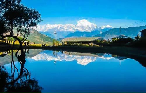 a reflection of a mountain in a body of water at Homestay in Baglung Bazar -Baglung Homestay in Bāglung