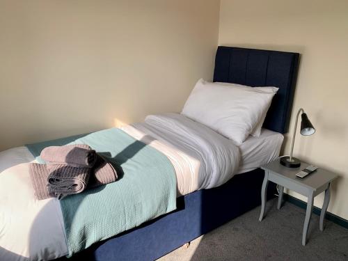 a small bedroom with a bed and a night stand at The Bridge Inn in Tenbury
