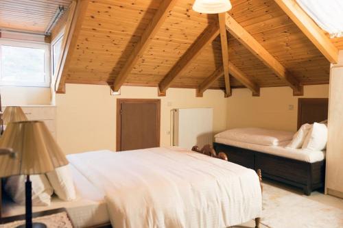 a bedroom with two beds and a wooden ceiling at Cozy Σοφίτα in Ioannina