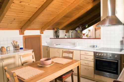 a kitchen with a wooden table and a stove at Cozy Σοφίτα in Ioannina