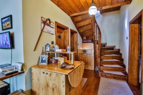 a home office with a wooden desk and a staircase at Kum Butik hotel in Amasra