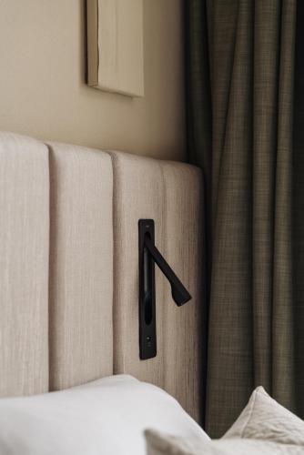 a black handle on the side of a bed at Adam Suites Hotel in Amsterdam