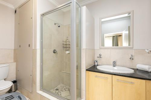 a bathroom with a shower and a sink at RAD STAYS - 60 Westpoint 89 Grayston Dr Morningside in Johannesburg