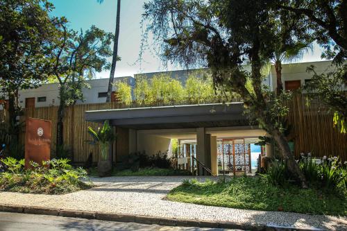 a house with a balcony on top of it at Wyndham Ilhabela Casa Di Sirena in Ilhabela