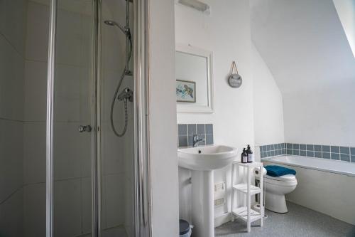 a bathroom with a shower and a sink and a toilet at The Becket - Three Bedroom City Centre House with Parking in Canterbury