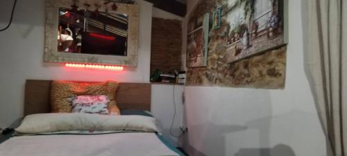 a bedroom with a bed and a picture on the wall at House of Artists-Aquilotto in Carrara