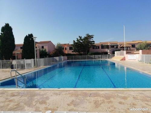 a large swimming pool with blue water at 746 Aphrodite naturiste in Leucate