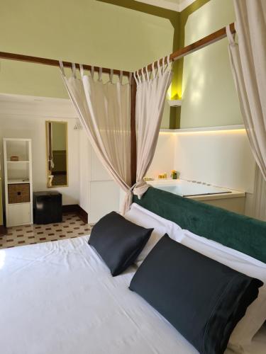 a bedroom with a bed and a tub in a room at Toscano Palace Luxury Rooms Catania in Catania
