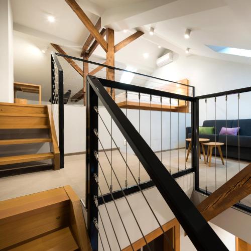 a staircase in a loft with a living room at Hotel Tři knížata in Jihlava