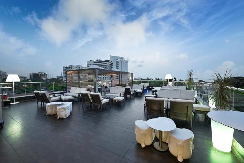 a rooftop patio with tables and chairs on a building at Maison Fahrenheit in Lagos